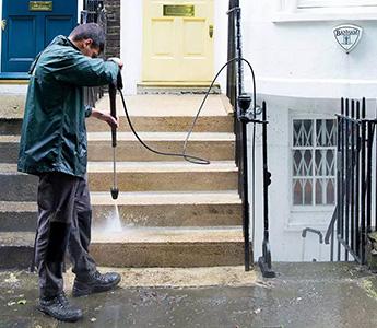 gardener jet washing stairs in London