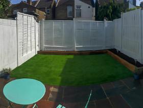 new artificial turf and white fence