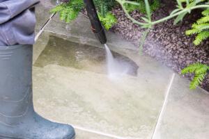 gardener jet washing a patio in Liverpool